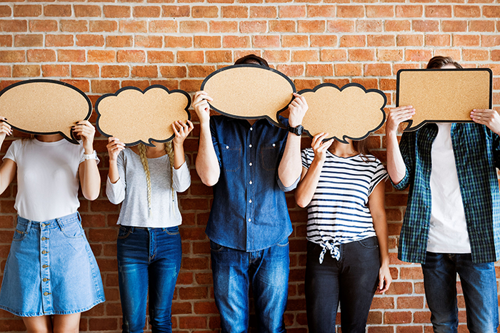 Photo of five people holding up different shapped thought bubbles over their faces